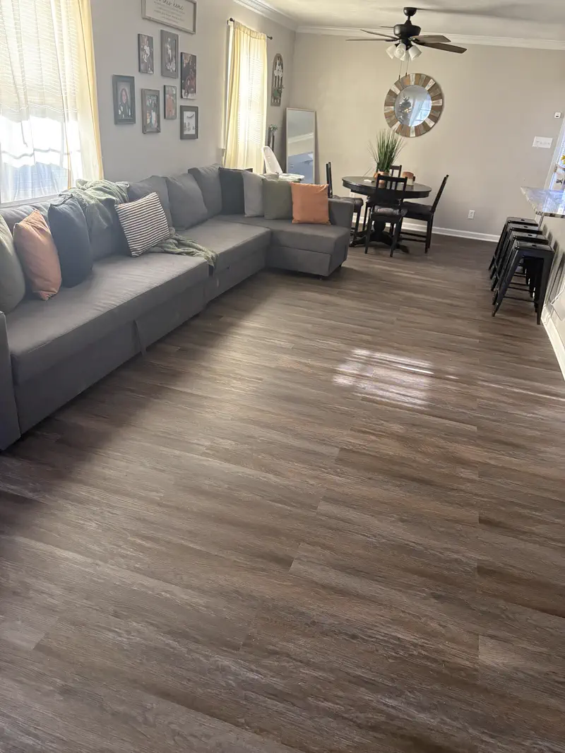 Vinyl plank floor running through a living and dining room